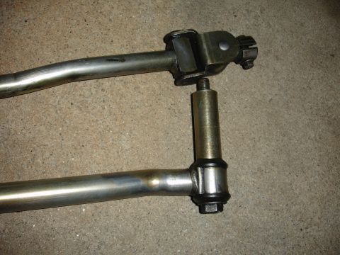 1993 Ford Taurus - Close-up of a vehicle steering linkage component, showing metal rods and a connecting joint.