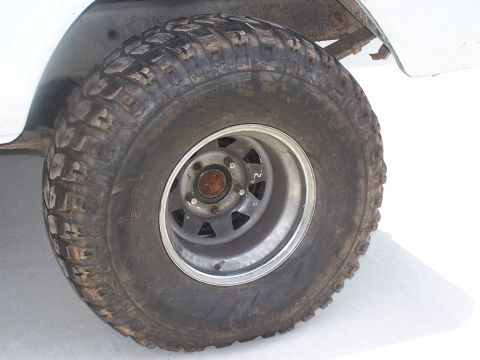 2007 Ford Bronco - This image shows a close-up of a tire and wheel assembly, with visible mud and tread detail.