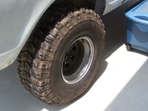 2007 Ford Bronco - A close-up shot focuses on the aggressive tread of an off-road tire mounted on a vehicle's wheel.