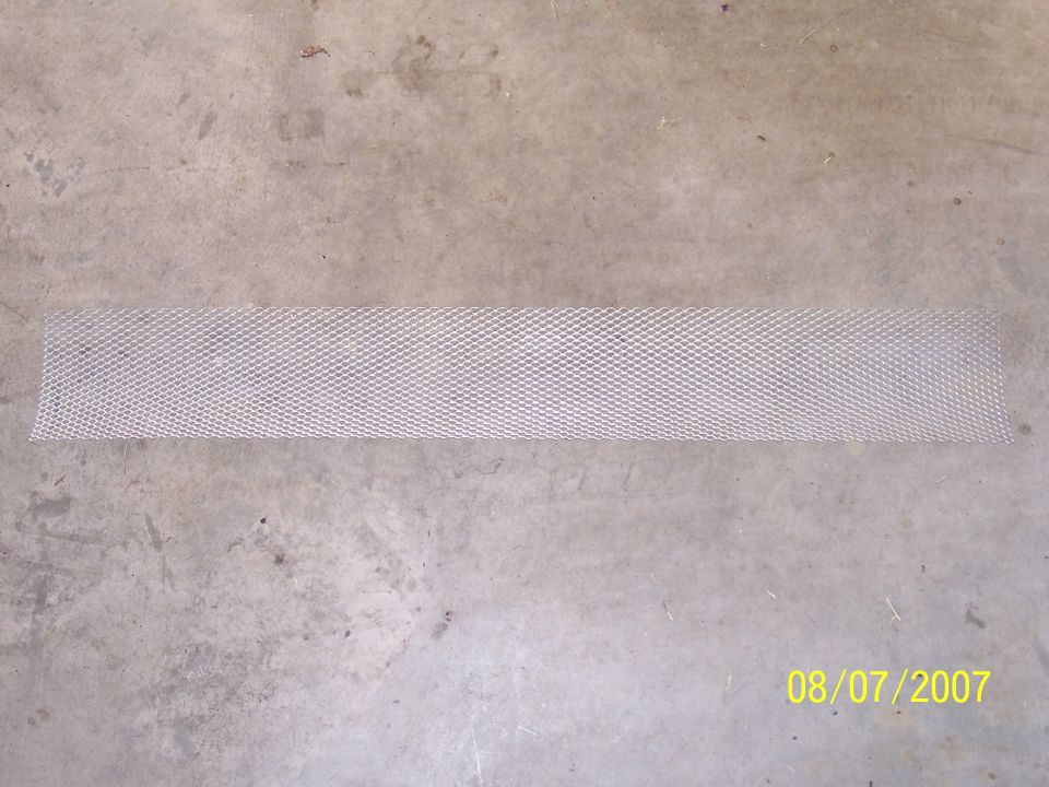 Long strip of silver expanded aluminum mesh on concrete floor, dated 08/07/2007