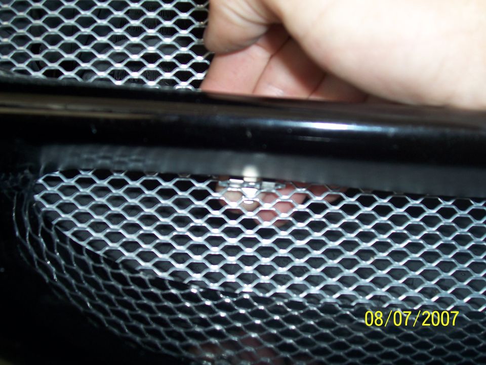 You can reach the top clip like so, careful the metal is sharp