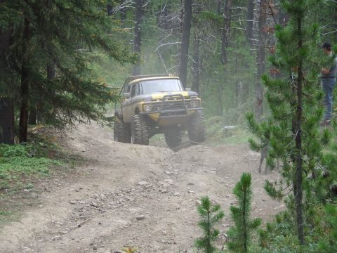 1990 Ford Bronco - Modified 1978 Ford F-150 navigates a rough, dusty trail in a wooded area.