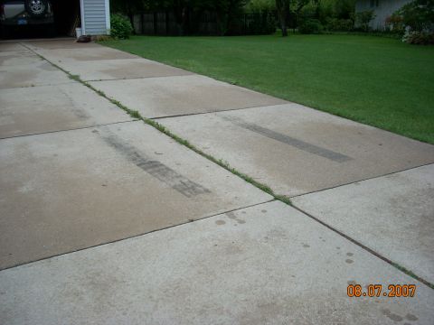 2000 Chevrolet Tahoe - Tire marks are visible on a concrete driveway in front of a garage.