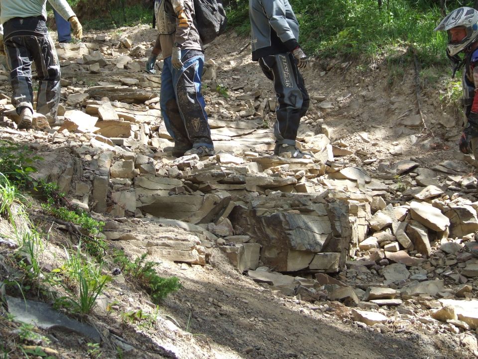 People walking up a steep, rocky trail