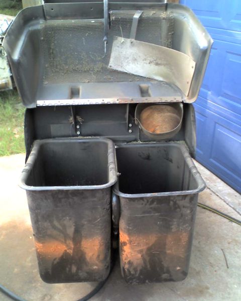 1965 Ford Mustang - This is a lawn mower bagger attachment with two collection bins and a metal chute, likely for grass clippings.