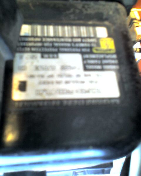 1965 Ford Mustang - A close-up view of a label with a barcode and various text elements is visible.