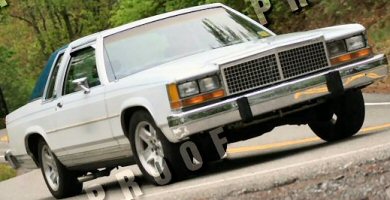 1985 Ford Crown Victoria LTD - 1985 Ford Crown Victoria LTD two-door sedan seen from the front-right on a road.