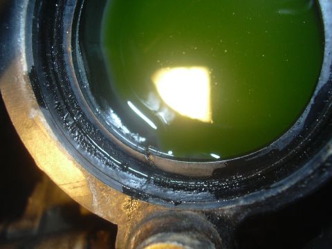 1997 Ford Crown Victoria - Close-up of a cracked intake manifold showing green coolant inside.