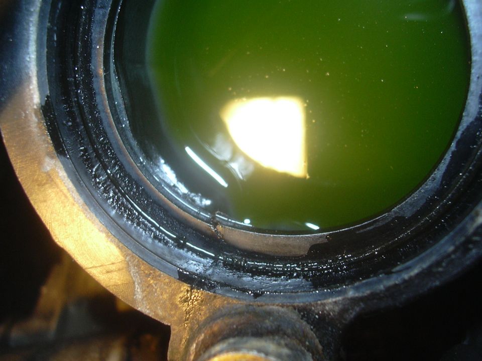 Cracked intake manifold with green coolant visible