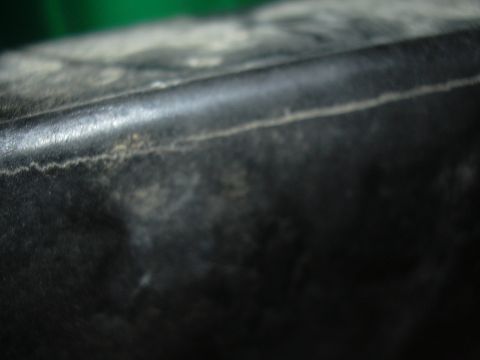 1997 Ford Crown Victoria - A close-up view of a cracked plastic component, with the Supermotors.net logo visible in the lower right corner.