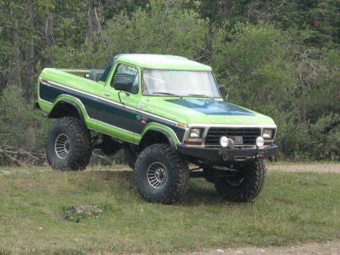 1995 Ford Bronco - This heavily modified Bronco, likely from the late 1970s, sits high on off-road suspension and tires.