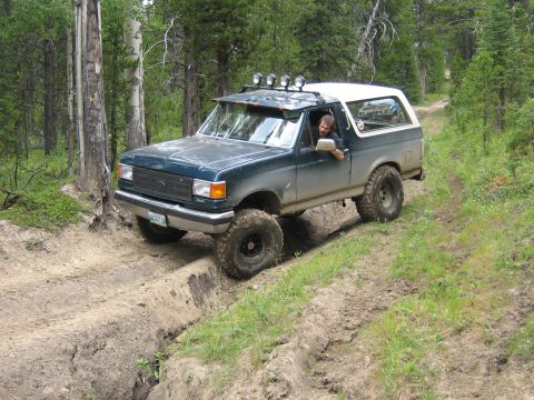 1995 Ford Bronco - This 1995 Ford Bronco is shown tackling an off-road trail through a forest.