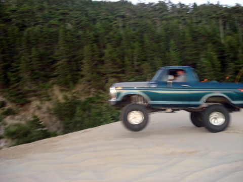 1979 Ford Bronco - This lifted 1979 Ford Bronco is shown driving on a sand dune during an event.