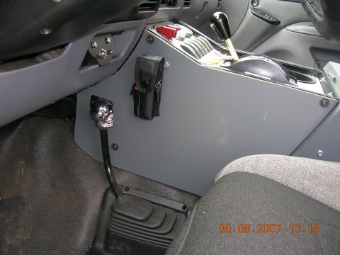 1996 Ford Bronco - Interior view of a vehicle's center console, a skull-shaped gear shift knob and a toggle switch.