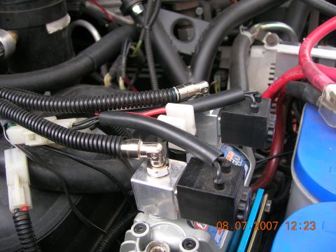 1996 Ford Bronco - Engine bay components including air compressor parts and wiring are visible in this close-up shot.