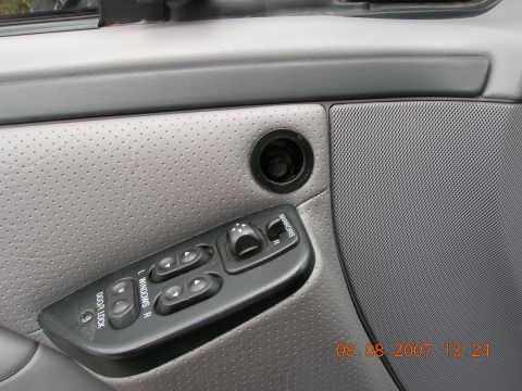 1996 Ford Bronco - Close-up of the driver's side door interior, showing the power window and mirror controls.