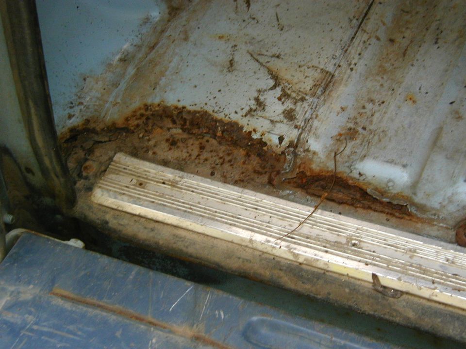 rusted out floor panel and trim inside a vehicle
