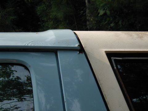 1986 Ford Bronco - The seam between the door and roof of this vehicle shows signs of wear and tear.