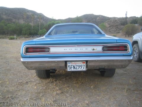 1968 Ford Mustang - Rear view of a blue 1968 Dodge Coronet parked outdoors with a silver SUV to the right.
