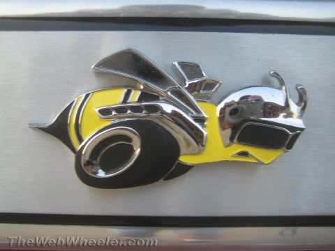 1968 Ford Mustang - A close-up of a yellow and black bee emblem, likely a car badge.