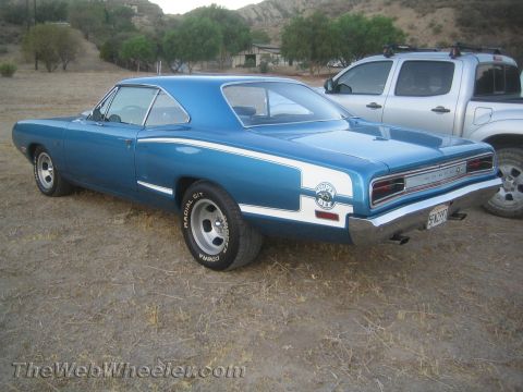 1968 Ford Mustang - 1968 Dodge Super Bee coupe in blue with white stripe detail, seen parked outdoors.