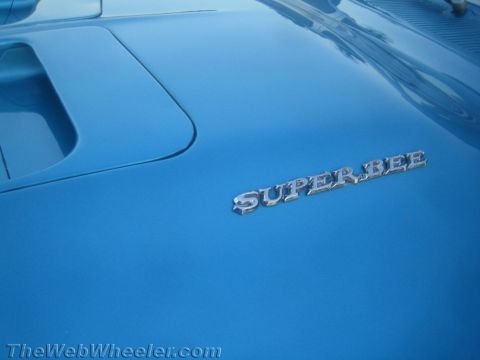 1968 Ford Mustang - A close-up of a blue car's hood displays the 'SUPER BEE' emblem.