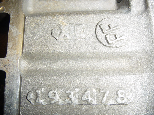 Cast metal part with embossed markings 'XE', 'PF', and '1933478'