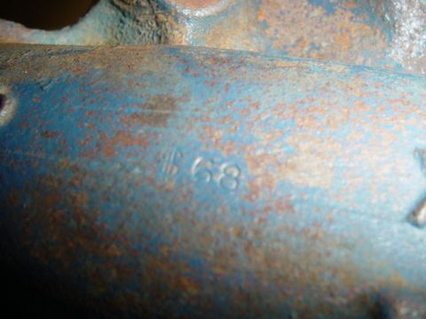 1979 Ford F-150 - Close-up of a blue painted metal part showing stamped numbers '1 68'.