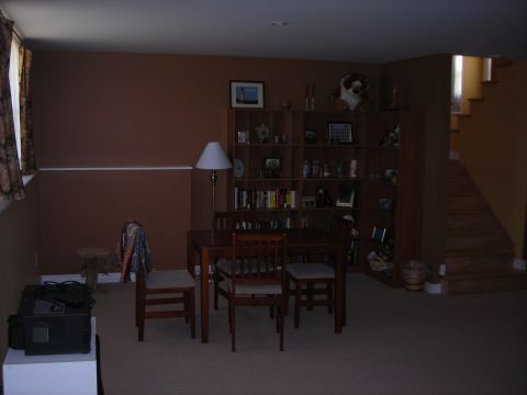 1984 Ford Bronco - A room interior a dining set, a large bookshelf, and a staircase.