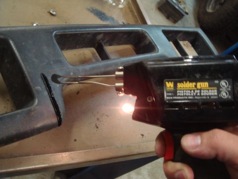 1996 Ford Bronco - A WEN solder gun is used to melt black plastic dashboard trim.