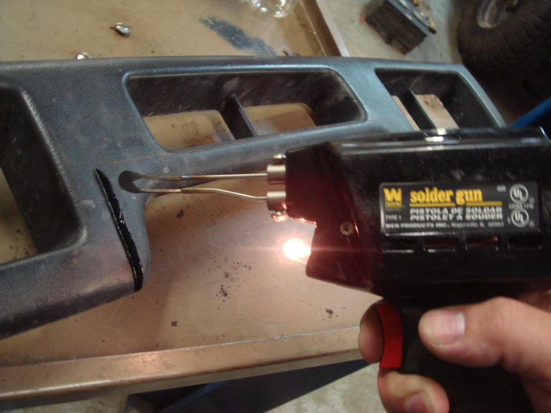 Black dashboard trim being melted by a WEN solder gun