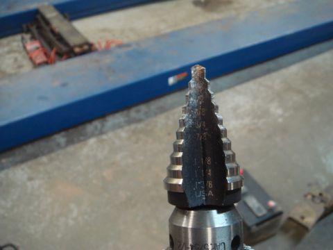 1996 Ford Bronco - A step drill bit is shown with various size measurements etched onto its surface.