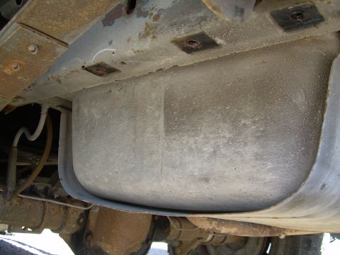 1991 Ford Bronco - Close-up of a vehicle's fuel tank and chassis structure, showing suspension and frame elements.