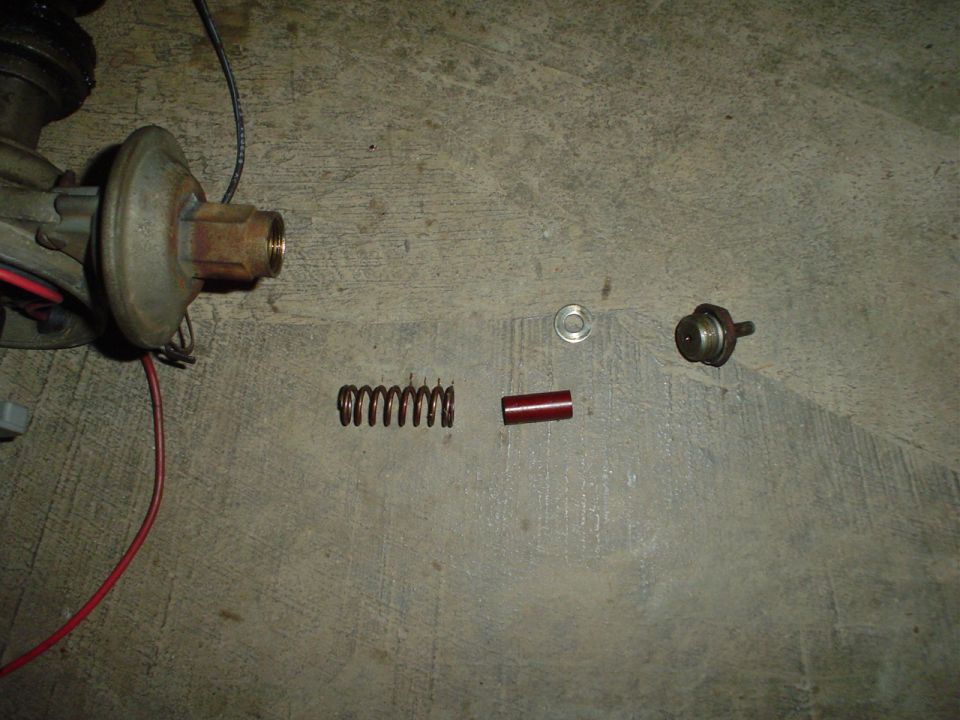 Distributor with spring, red sleeve, and washer on concrete