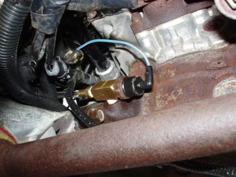 1993 Ford Taurus - Engine sensor and wiring detail, showing connection to engine block and exhaust manifold.