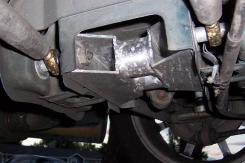 1993 Ford Taurus - Close-up view of a custom-welded metal bracket attached to the undercarriage of a vehicle.