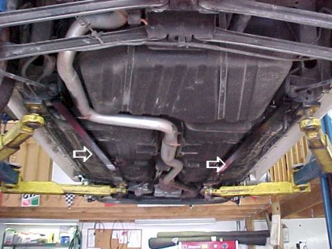 1993 Ford Taurus - A view of the vehicle's undercarriage, highlighting the exhaust and suspension parts.