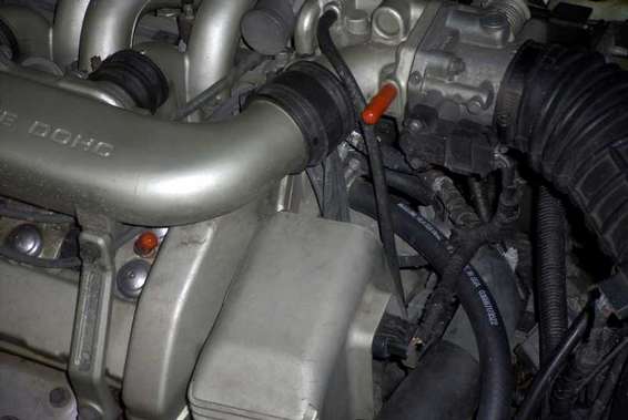 Engine bay of a 1993 Ford Taurus showing intake manifold and throttle body