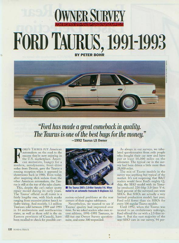 Side view of a silver 1992 Ford Taurus sedan driving on a road