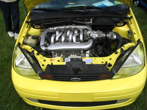 1993 Ford Taurus - Yellow Ford Focus engine bay shows aftermarket intake and engine components.