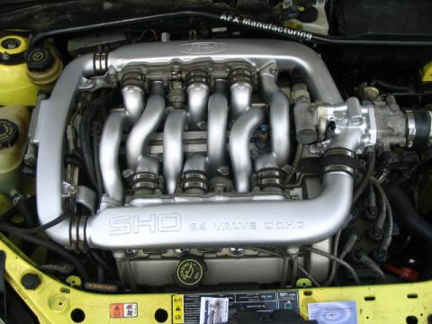 1993 Ford Taurus - The engine bay shows a Ford SHO V6 engine with its distinctive intake manifold and valve covers.