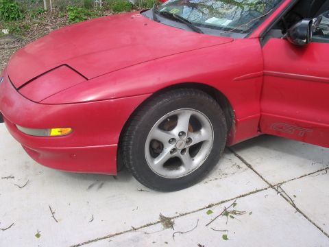 1995 Ford Probe - Front quarter view of a red 1995 Ford Probe GT with the driver's door open.