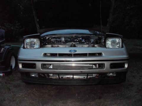 1989 Ford Probe - Front view of a silver 1989 Ford Probe with its hood open, revealing the engine bay.