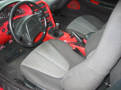 1995 Ford Probe - Interior view of a 1995 Ford Probe, showing the dashboard, seats, and center console with red accents.