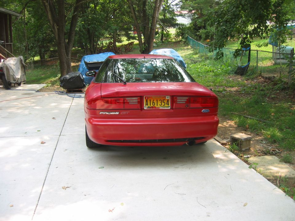 Red Ford Probe GT parked in driveway, rear view. License plate A161354