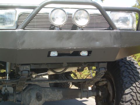 1993 Toyota 4Runner - This vehicle features a custom front bumper with auxiliary lighting, including two large round lights and two smaller rectangular ones.