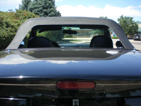 1996 Mazda Miata - Rear view of a black 1996 Mazda Miata convertible with the soft top in the up position.