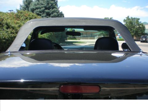 1996 Mazda Miata - Rear view of a black 1996 Mazda Miata convertible with its soft top up.