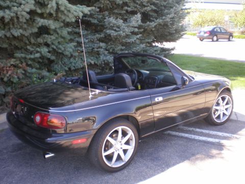 1996 Mazda Miata - This black 1996 Mazda Miata convertible is shown from a 3/4 front angle.