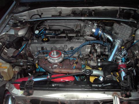 1989 Ford Probe - The engine bay shows modifications including a turbocharger and custom piping, with visible text from SuperMotors.net.